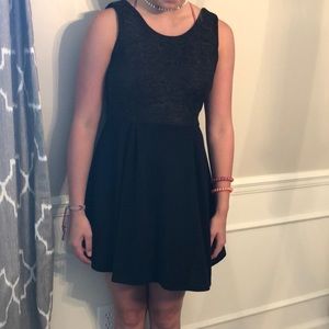 Black tank dress with glitter on the top.